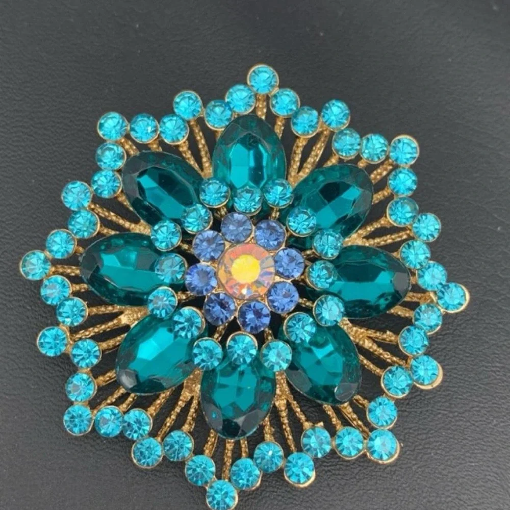 Gold tone and blue rhinestone brooch